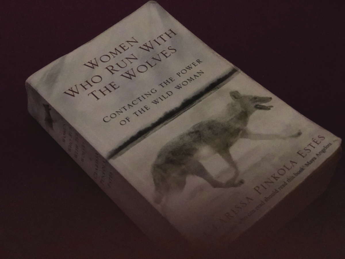 dark picture of book "Women who run with the wolves" by Clarissa Pinkola Estes